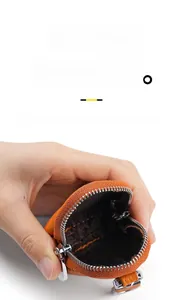 Detail showing the spacious interior of an orange pebble leather coin and key pouch