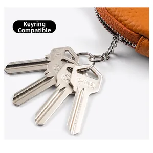 Detail of brown litchi pattern leather key pouch with silver zipper and chain hook