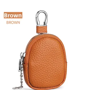 Macro view of brown lychee grain leather coin purse with metal zipper and key chain