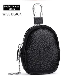 Detail of wise black pebble grain leather mini pouch with silver zipper and carabiner