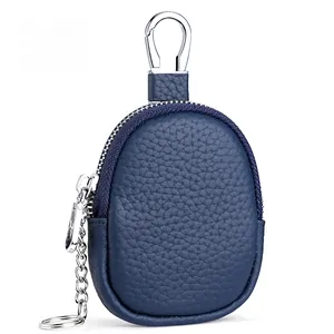 Detail of navy blue pebble leather coin purse with metal carabiner and zipper