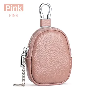 Detail of pink pebbled leather mini pouch with silver carabiner and key ring