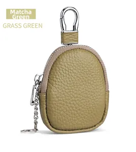 Detailed macro view of grass green pebble grain leather coin pouch with silver metal hardware