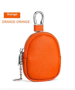 Detail of orange lychee grain leather coin purse with metal swivel hook and zipper