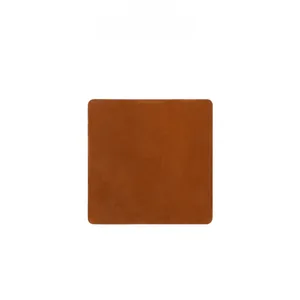 Detailed view of square tan crazy horse leather coaster with natural grainy texture