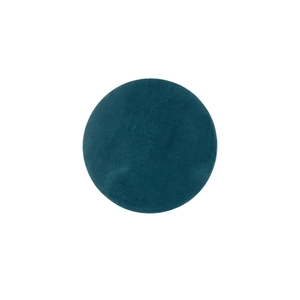 Macro detail of round dark blue crazy horse leather placemat with refined grain texture