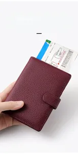 Close-up of a burgundy leather RFID passport holder with functional ticket compartments