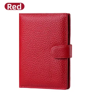 Close-up of a red RFID leather passport wallet with lychee texture and buckle closure