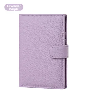 Detail of lavender purple RFID passport wallet showing lychee grain leather and snap closure