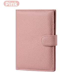 Detail of pink lychee leather passport wallet with side snap closure and stitching