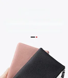 Close-up detail of genuine leather wallet with lychee pattern and metal zipper closure