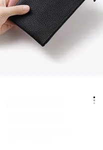 Close-up of black litchi grain leather wallet with durable metal zipper and pink lining