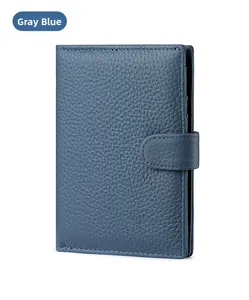 Close-up of greyish blue leather RFID passport wallet with lychee texture and snap button