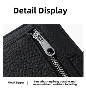 Close-up of durable silver hardware zipper on premium black lychee grain leather wallet