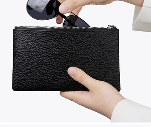 Close-up of black lychee leather wallet used as a storage case for large sunglasses