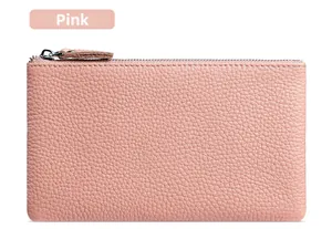 Detail shot of dusty pink litchi grain leather wallet with a silver zipper closure