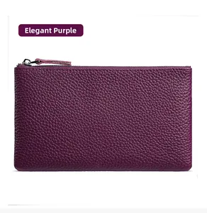 Close-up of elegant purple pebbled leather wallet with metal zipper and leather puller