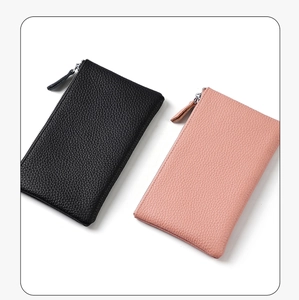 Detailed top view of black and pink pebble leather zip wallets on white background
