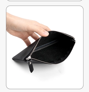 Macro shot of black litchi grain leather bag showing spacious interior and silver zipper