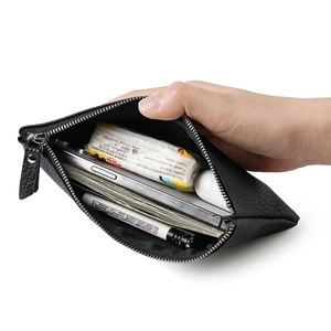 Minimalist black pebble leather organizer clutch showing spacious interior capacity