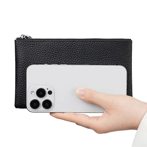 Black pebbled leather wallet case with silver zipper shown next to a smartphone