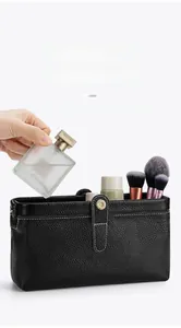 Litchi pattern leather cosmetic bag with metal clasp showing perfume bottle storage