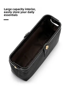 Internal view of the large capacity leather toiletry bag with premium gold metal clasp