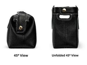 Detail of black pebble leather makeup bag with contrast stitching and gold button