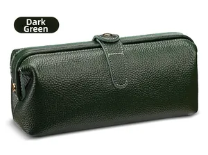 Close-up of dark green lychee grain leather makeup bag with contrast stitching