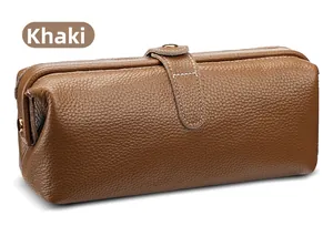 Macro detail of khaki litchi grain leather pouch with white stitching and metal clasp