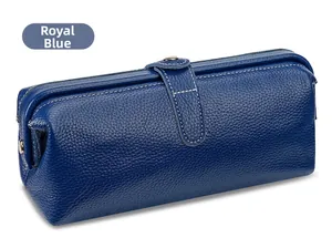 Close-up of royal blue leather cosmetic bag with litchi texture and buckle closure