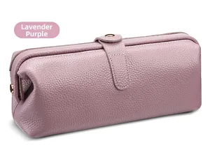 Detail of lavender purple pebbled leather toiletry bag with elegant gold hardware