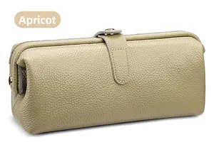 Detail view of apricot lychee texture leather vanity bag with golden buckle closure