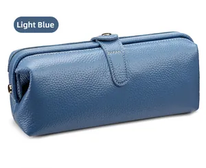 Close-up of light blue pebble grain leather pouch with metal snap button and fine stitching