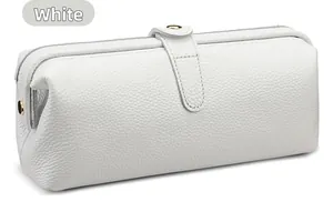 Close-up of white litchi pattern leather toiletry bag with elegant metal magnetic clasp