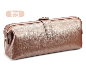 Rose gold leather toiletry bag with pebble texture and leather strap snap closure detail