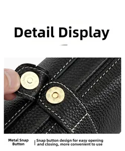 Close-up of black litchi grain leather bag featuring a polished gold magnetic snap buckle