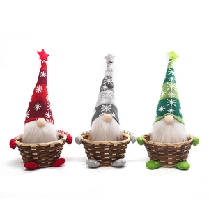 Three Christmas gnome candy baskets with snowflake hats and brown woven bamboo holders