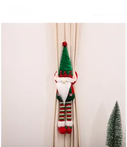 Detail of Christmas elf curtain buckle with plush gnome, long beard and striped legs