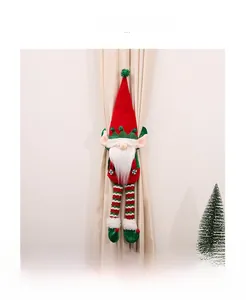 Detail of Christmas elf curtain tieback with long legs and classic festive red and green colors