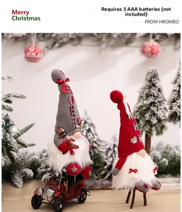 Illuminated Christmas gnomes with Noel embroidery and vintage car detail on snowy background