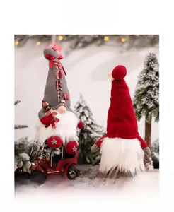 Detailed view of grey and red Christmas gnomes with Noel embroidery and plaid accents