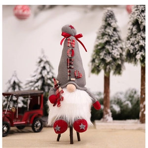 Close-up of Nordic Christmas gnome with NOEL lettering and plaid tree detail