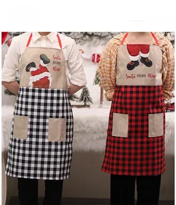 Detail of Christmas apron with Santa print, plaid pockets, and burlap texture