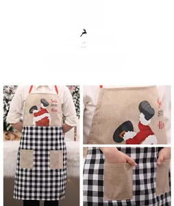 Detail of Christmas apron with Santa embroidery, large pockets and black-white plaid fabric