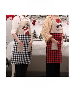 Detailed view of checkered Christmas apron with Santa pattern and dual front pockets