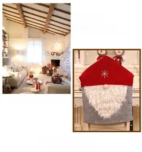 Detail of Santa gnome chair cover with a red star hat and white plush beard decor