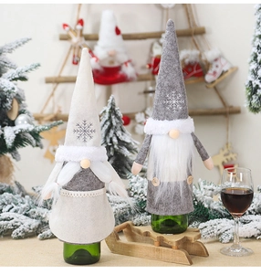 Detail of Christmas gnome wine bottle covers with snowflake embroidery and faux fur trim