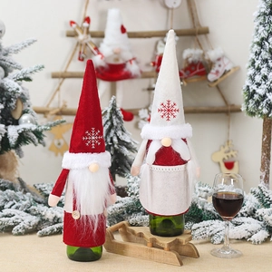 Red and white Christmas gnome wine bottle covers with faux fur beard for holiday table decor