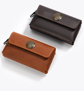 Close-up of vintage crazy horse leather wallets with Indian head metal emblems